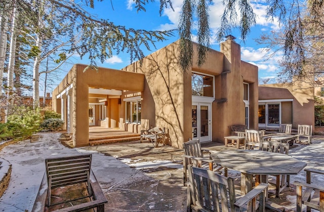 back of property with french doors and a patio area