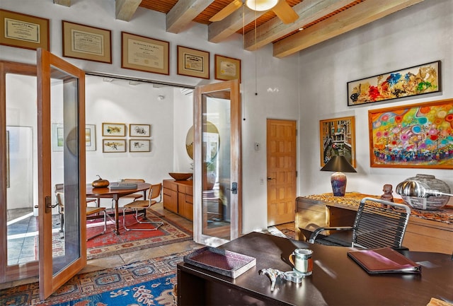 tiled home office with beamed ceiling, ceiling fan, and french doors