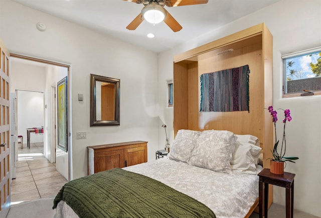 bedroom with light tile patterned floors and ceiling fan