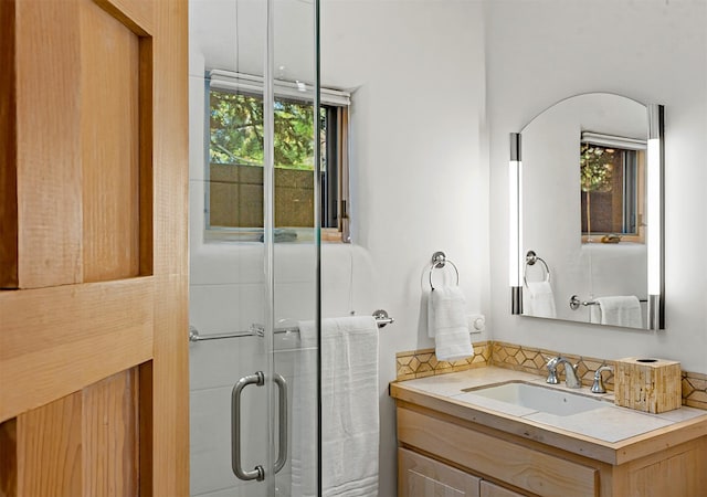 bathroom with walk in shower and vanity