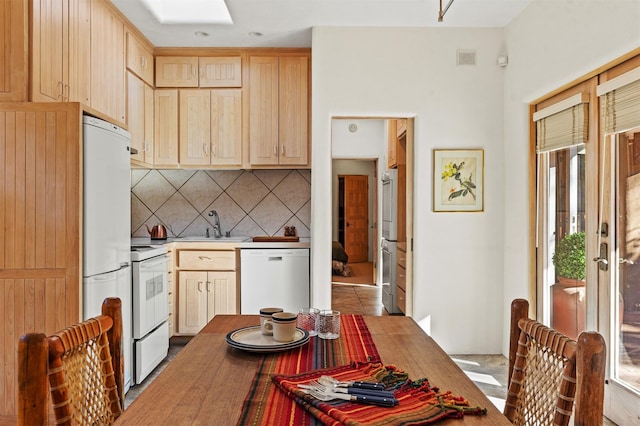 kitchen featuring white appliances, sink, decorative backsplash, and light brown cabinets