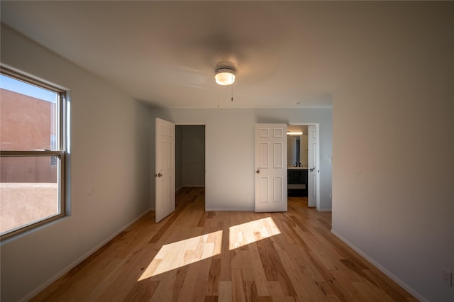 unfurnished bedroom featuring light hardwood / wood-style floors and ceiling fan