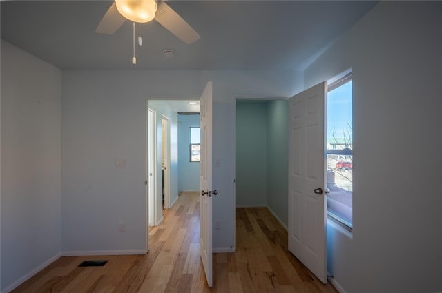 hallway with light hardwood / wood-style floors