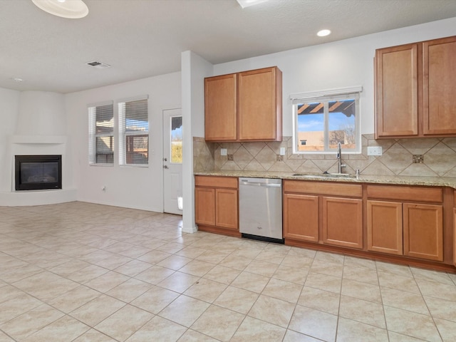 3110 Floras Del Sol, Santa Fe, NM 87507 - kitchen featuring light stone countertops, tasteful backsplash, dishwasher, sink, and light tile patterned flooring