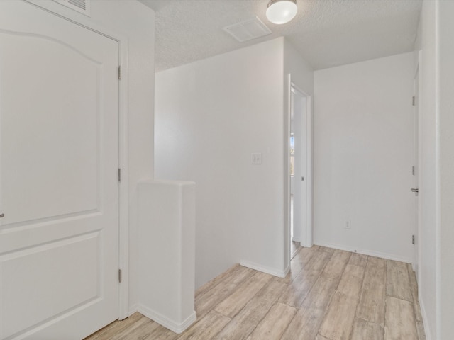 3110 Floras Del Sol, Santa Fe, NM 87507 - corridor with light wood-type flooring and a textured ceiling