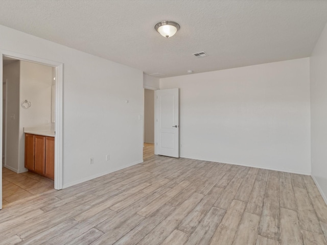 3110 Floras Del Sol, Santa Fe, NM 87507 - empty room with light hardwood / wood-style flooring and a textured ceiling