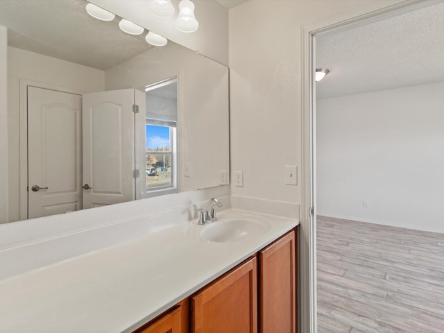 3110 Floras Del Sol, Santa Fe, NM 87507 - bathroom with wood-type flooring, a textured ceiling, and vanity