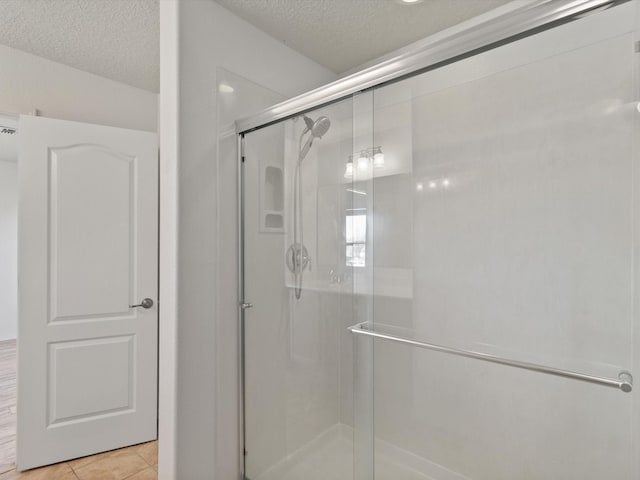 3110 Floras Del Sol, Santa Fe, NM 87507 - bathroom featuring a textured ceiling, tile patterned flooring, and a shower with shower door
