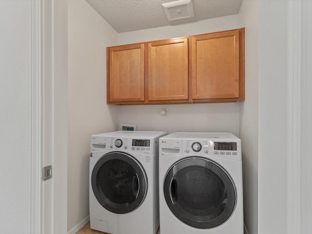 3110 Floras Del Sol, Santa Fe, NM 87507 - laundry area with independent washer and dryer, cabinets, and a textured ceiling