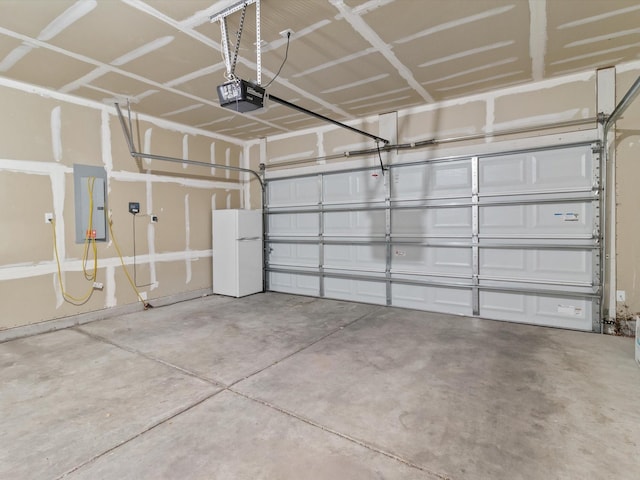 3110 Floras Del Sol, Santa Fe, NM 87507 - garage with a garage door opener, electric panel, and white fridge