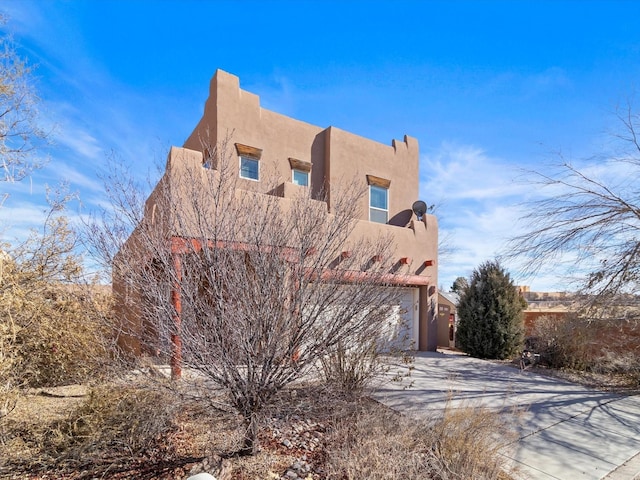 3110 Floras Del Sol, Santa Fe, NM 87507 - view of home's exterior with a garage