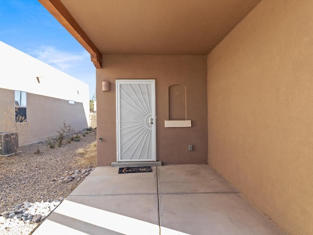 3110 Floras Del Sol, Santa Fe, NM 87507 - view of exterior entry with a patio area and central AC