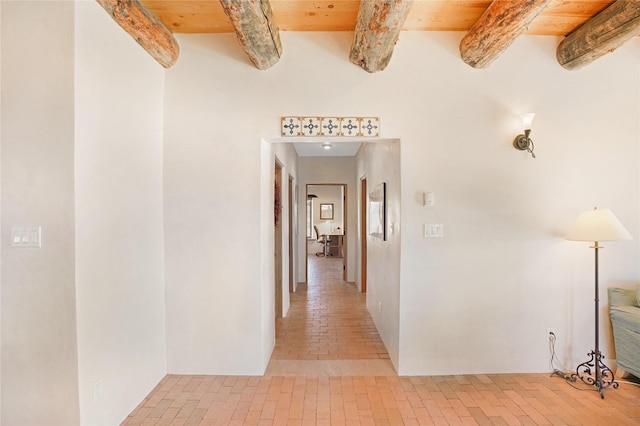 hallway featuring wood ceiling and beamed ceiling