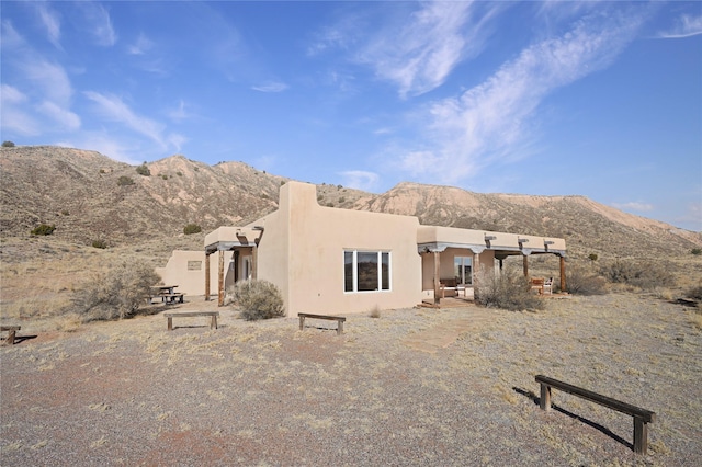 back of house with a mountain view