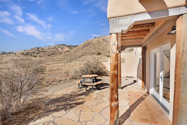 view of patio featuring a mountain view and french doors