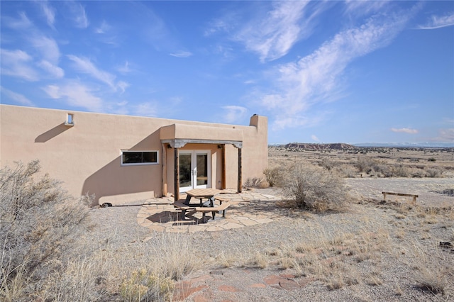 back of house featuring a patio and french doors