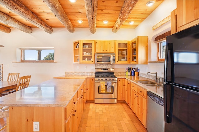 kitchen with light brown cabinetry, sink, a center island, stainless steel appliances, and beam ceiling