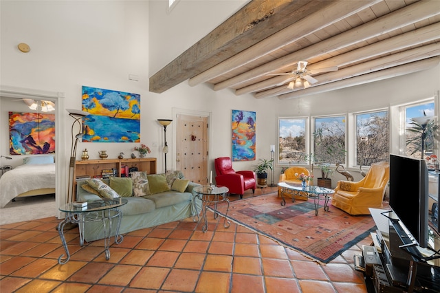 living room with beamed ceiling, ceiling fan, wood ceiling, and tile patterned flooring