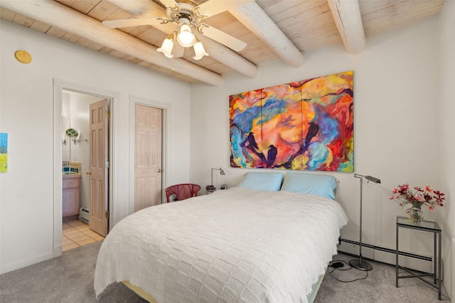 carpeted bedroom featuring ceiling fan, baseboard heating, beam ceiling, connected bathroom, and wooden ceiling