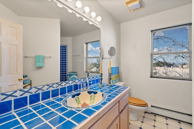 bathroom featuring vanity, a baseboard radiator, and toilet