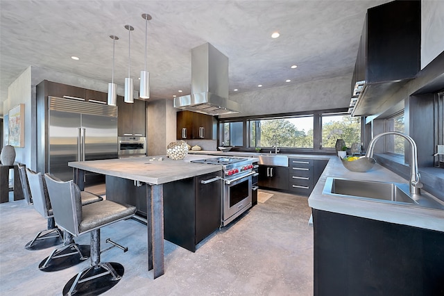 kitchen with dark brown cabinetry, sink, island range hood, a center island, and high quality appliances