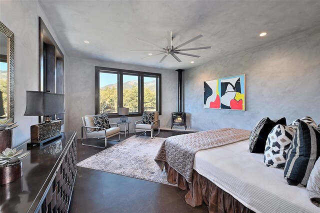 bedroom with ceiling fan and a mountain view