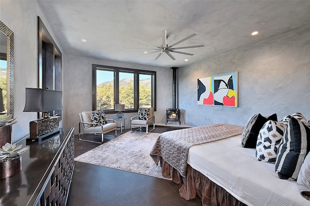 bedroom with ceiling fan and a wood stove