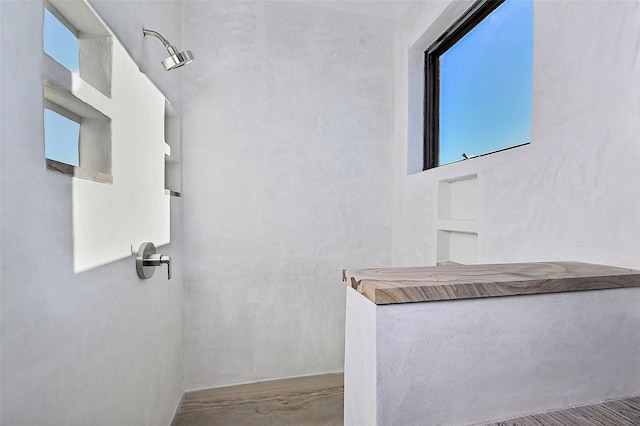 bathroom with a shower and concrete floors