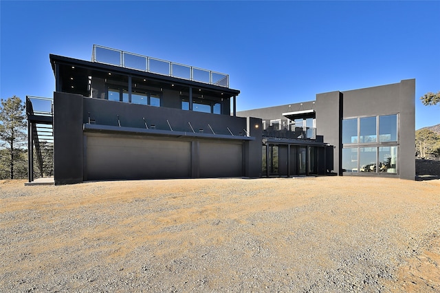 back of house featuring a garage