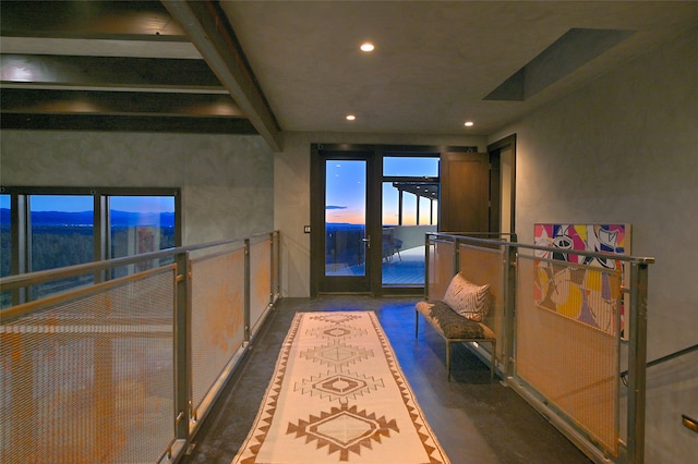 hallway featuring beam ceiling