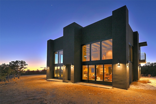 back house at dusk with french doors