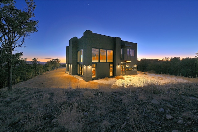 view of back house at dusk