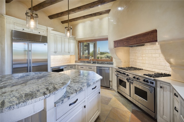 kitchen featuring beamed ceiling, white cabinets, premium appliances, and decorative light fixtures