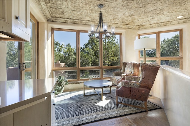 sunroom / solarium with a notable chandelier