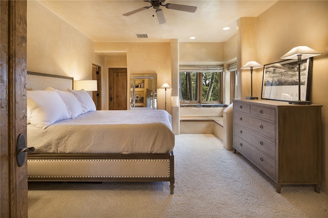 bedroom with light carpet and ceiling fan