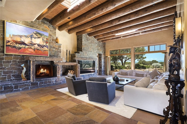 living room with a stone fireplace, a towering ceiling, wooden ceiling, and beam ceiling