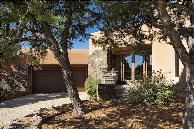 pueblo revival-style home featuring a garage