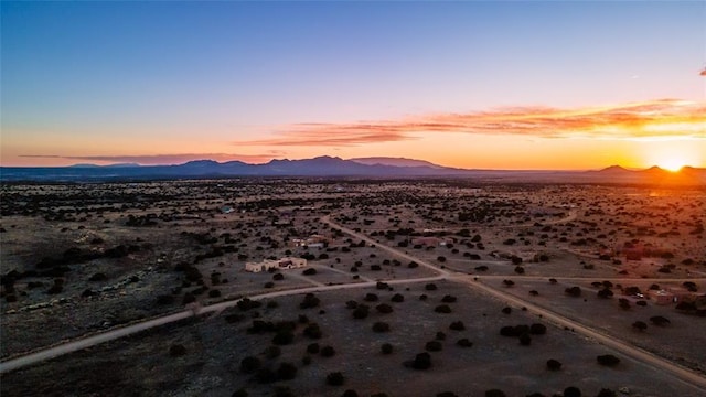 aerial view at dusk featuring a mountain view