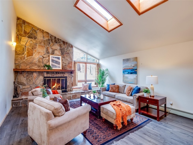 living room with lofted ceiling with skylight, wood-type flooring, and a fireplace