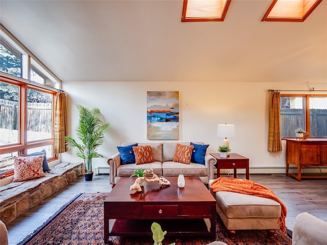 living room with wood-type flooring, plenty of natural light, and baseboard heating