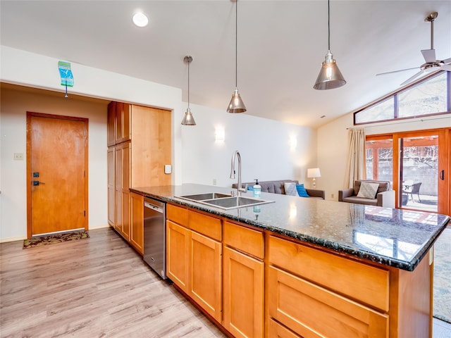 kitchen featuring lofted ceiling, sink, dishwasher, dark stone countertops, and decorative light fixtures