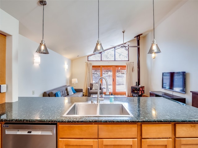 kitchen featuring sink, decorative light fixtures, vaulted ceiling, and stainless steel dishwasher