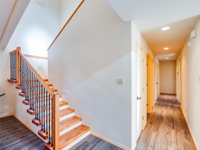 stairway with hardwood / wood-style floors