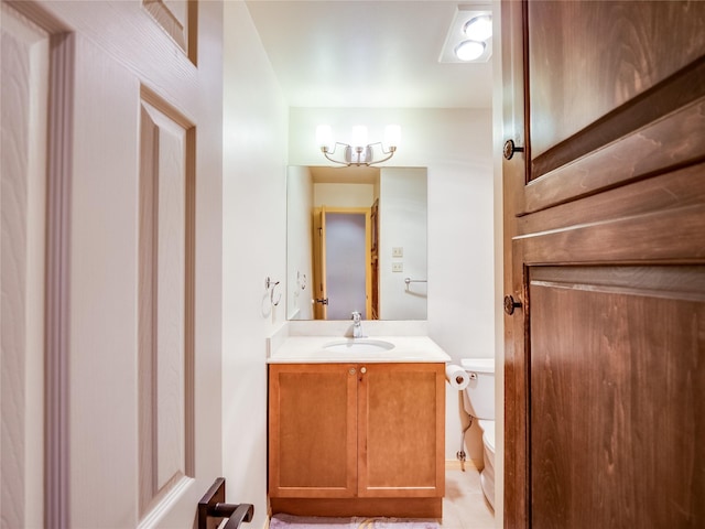 bathroom featuring vanity, tile patterned flooring, and toilet