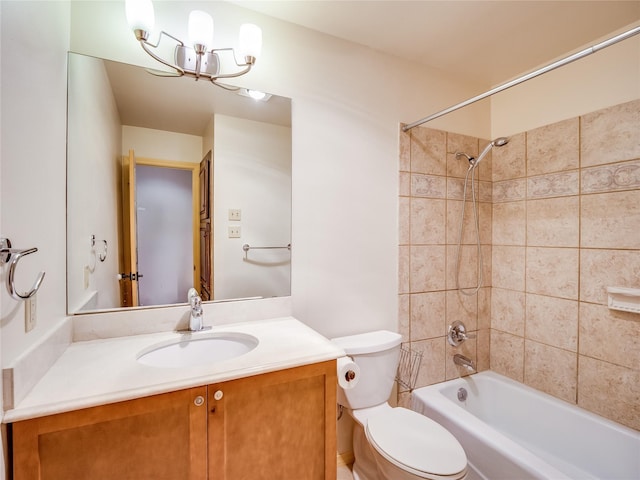 full bathroom with vanity, toilet, and tiled shower / bath