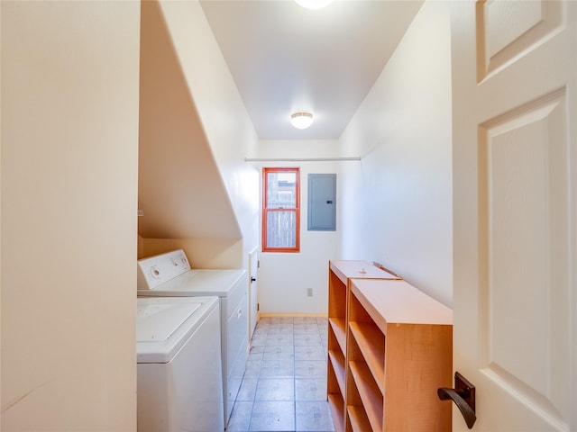 laundry room featuring electric panel and washer and clothes dryer