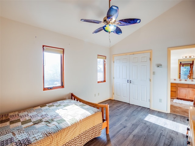 unfurnished bedroom with hardwood / wood-style floors, lofted ceiling, ceiling fan, ensuite bath, and a closet