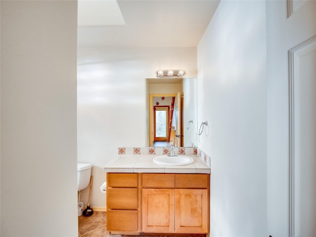 bathroom with vanity, tile patterned floors, and toilet