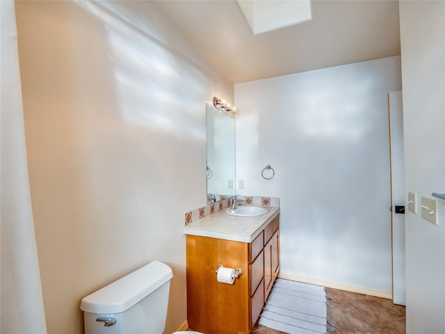 bathroom featuring vanity, tile patterned floors, and toilet