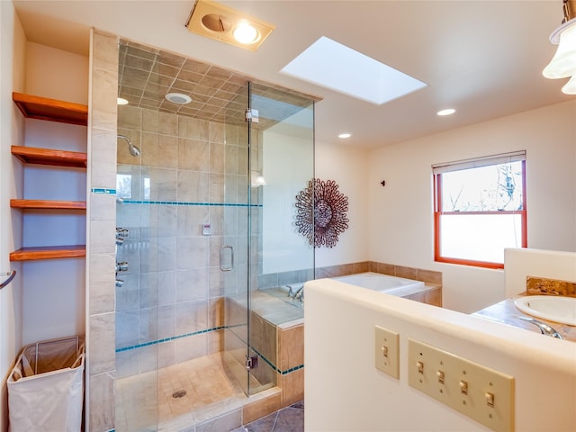 bathroom with separate shower and tub, vanity, a skylight, and tile patterned flooring